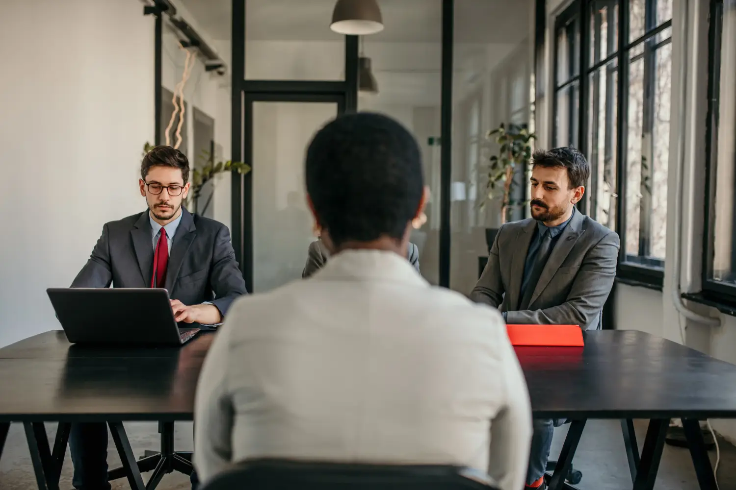 A businesswoman asking questions to hiring managers during a job interview