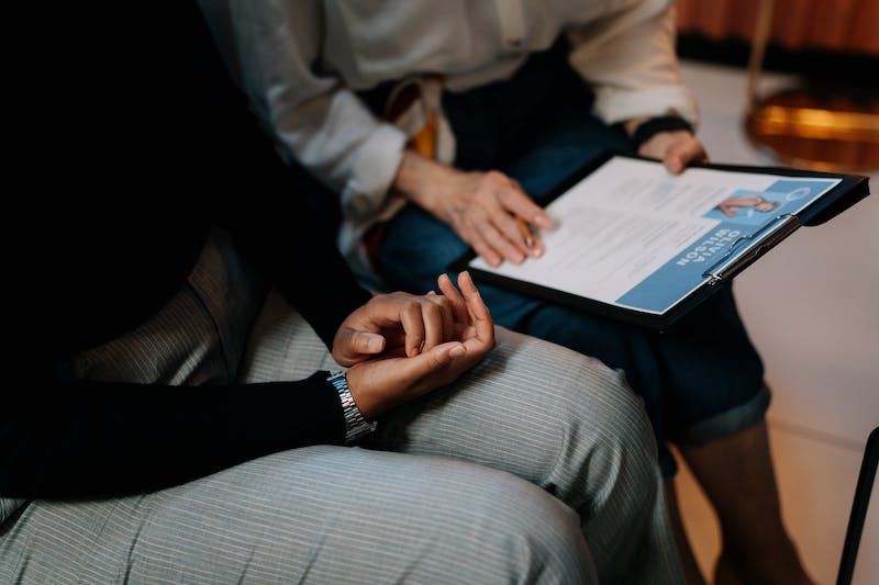 A photo of two women looking at a resume. One of them is a resume writer.